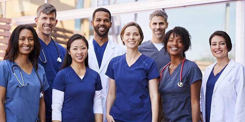 Group of doctors standing outside smiling
