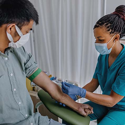 Nurse preparing patient to do blood analysis