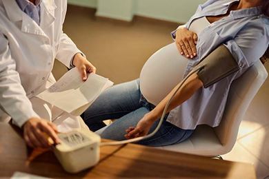 Pregnant woman having her blood pressure checked during an appointment