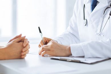 Close up of patient and doctor taking notes