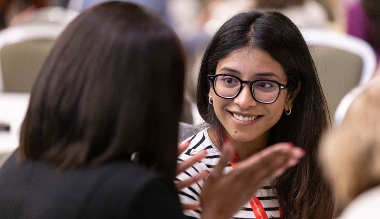 Two women catch up during a luncheon at Hypertension 2023.