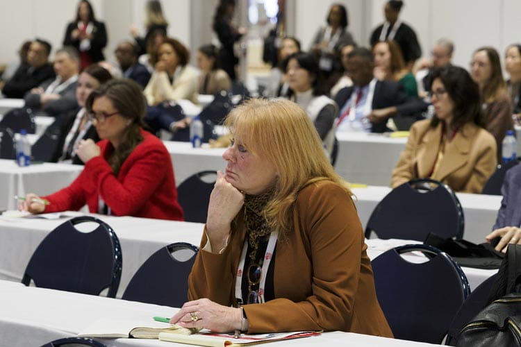 Audience members listen intently during a presentation on cardiovascular and kidney health at #AHA24 in Chicago.