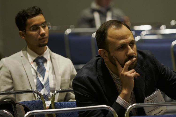 Audience members listen intently during the International Symposium in 2024.
