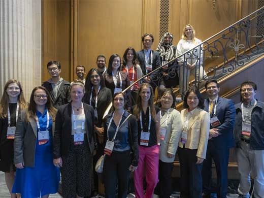 Attendees pose on a staircase during Vascular Discovery 2024.