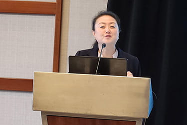 Close up of PVD Council Chair, Dr. Esther Kim, presenting at the May 14th COC meeting in Dallas, TX.