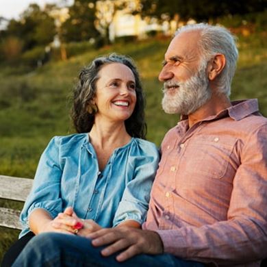 Woman and man sitting in park bench