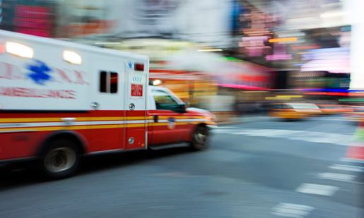 ambulance zooming through city streets