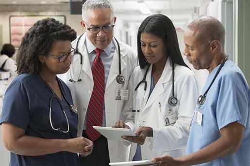 doctors and nurses reviewing medical chart in hospital