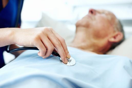 expert_care_and_professional_support Closeup of a doctor's hand that is holding a stethoscope to an elderly patient's chest