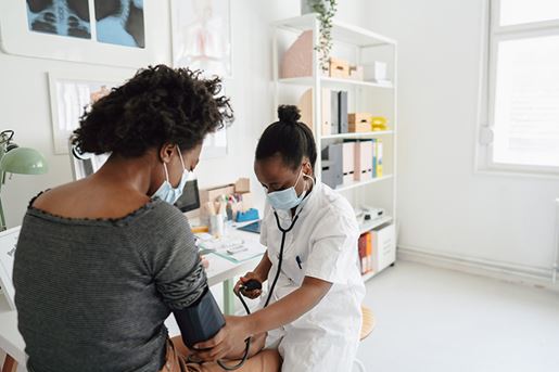 Female doctor checking the patient's blood pressure