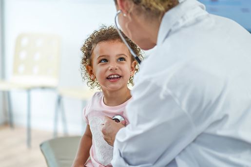 Doctor listening to a child's heartbeat
