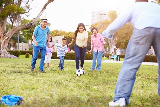Multi Generation Family Playing Soccer Together