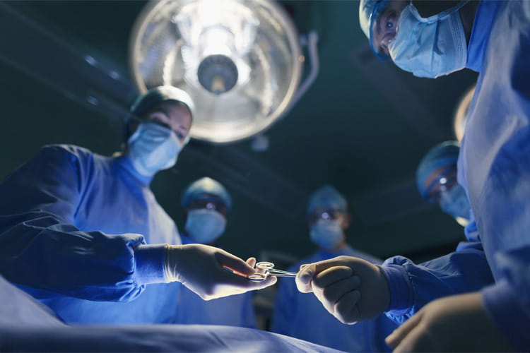 operating room staff performing surgery