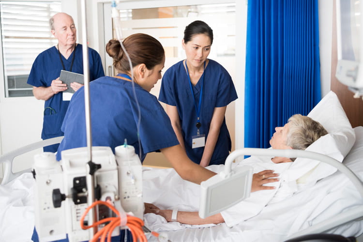 patient in bed and medical staff